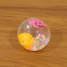 Light-up transparent sensory bouncy ball being used for fun