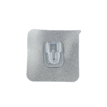 GlimmerHome transparent adhesive hook discreetly blending into a white wall.
