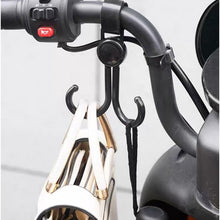 Multi-purpose stroller hook holding shopping bags and a purse on a pram.
