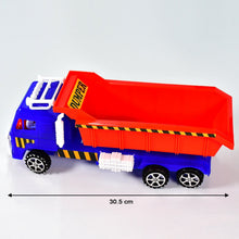 A child excitedly pushing the Friction Power Truck Toy across the floor.
