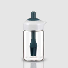 Glass oil dispenser with a brush, ideal for grilling, baking, or general cooking.