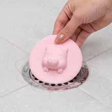 Silicone floor drain cover in use within a bathroom setting, providing drain protection.