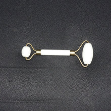 Dual-ended face massage roller displayed on a minimalist white background.