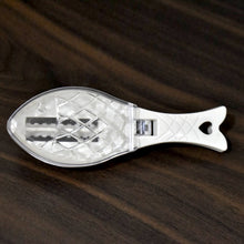 The compact Fish Scale Scraper with a hanging hole for convenient storage.