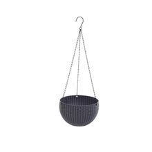 Detail of the drainage hole with a removable plug in the base of a plastic hanging flower pot.