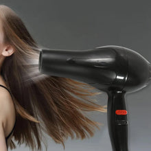 Hair dryer in action, creating a sleek hairstyle for Indian hair.