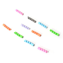 Assorted silicone spiral data cable protection units bundled together.