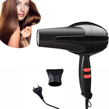 A black hair dryer with a nozzle attachment and power cord, with an inset circular image of a woman with shiny hair.