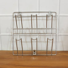 Close-up of stainless steel wall-mounted mug and cup holder rack