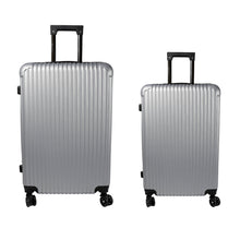 A person effortlessly pulling the smaller multi-color luggage bag through an airport.