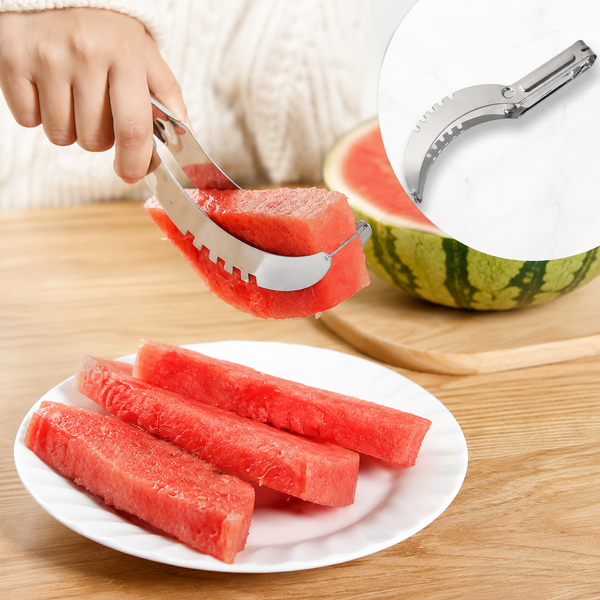 A hand uses a stainless steel watermelon slicer to lift a slice of red watermelon from a larger fruit.