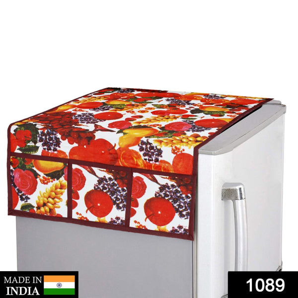 A fruit-patterned refrigerator top cover on a silver fridge, with a "Made in India" label and product number 1089.