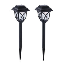 FitFuzion solar pathway lights casting bright, artistic patterns on a dark garden path, enhancing outdoor decor.