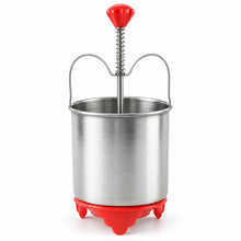 A stainless steel medu vada maker with a red handle and red base is shown against a plain white background.