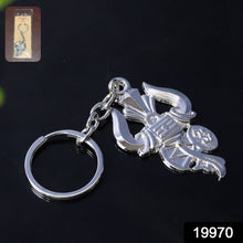 Close-up of intricate silver Trishul and Damru details on keychain