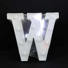W shaped LED decorative light positioned on shelf as home decor
