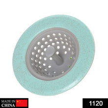 A mint green and gray sink strainer is shown from above, with a 
