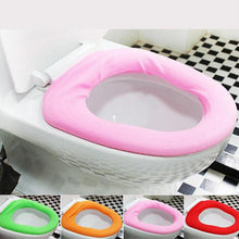 A pink soft fabric toilet seat cover on a white toilet with four smaller insets showing green, orange, pink, and red covers.