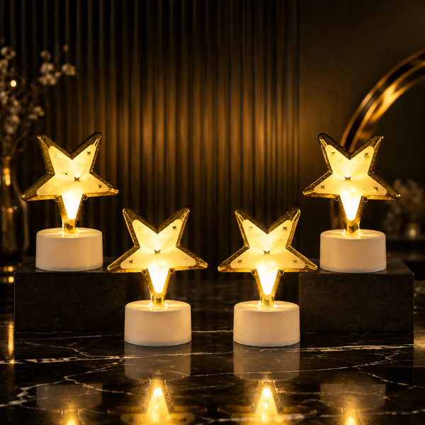 Four glowing star-shaped LED lights arranged on a dark marble surface with a blurred background.