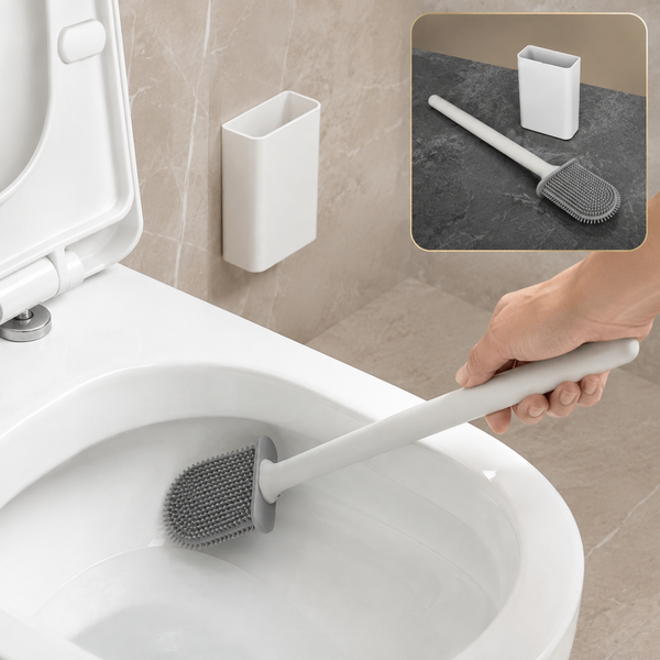 A hand holds a gray silicone toilet brush cleaning inside a white toilet bowl, with a wall-mounted holder.