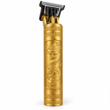 A gold-colored hair trimmer with an embossed dragon design and intricate patterns stands upright on a white surface.