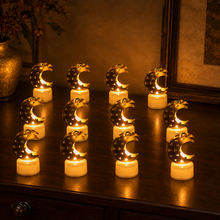 Twelve crescent moon shaped flameless LED candles with gold tops and white bases arranged on a dark wooden surface.