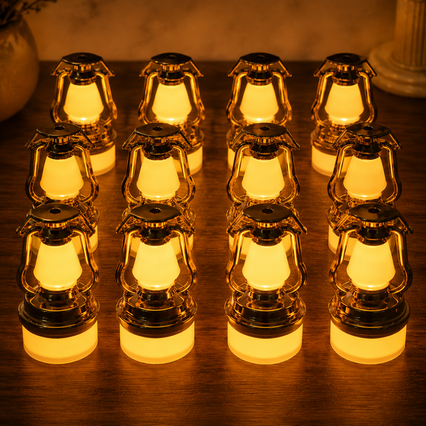Twelve small gold and white LED lanterns with warm glow arranged on a dark wooden surface.