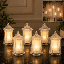 Six clear plastic lanterns with warm glowing LED lights sit on a dark marble surface, with more lanterns hanging in an inset