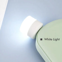 A bright USB bulb providing ambient light for a desk setup in an office environment.
