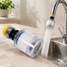 A clear plastic swivel faucet aerator with a yellow base, attached to a chrome faucet, spraying water into a sink.