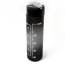 Person holding the sleek black motivational water bottle during a workout session.