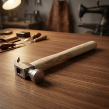 Close-up of steel head on claw hammer with wooden handle