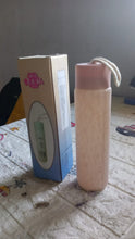 Hand holding the compact 350ml glass water bottle, ready for travel or daily use.