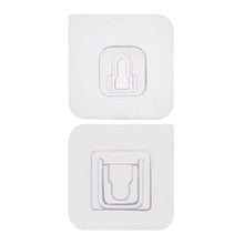 Adhesive wall hooks holding various kitchen utensils, showcasing their versatile use.