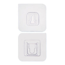 Two white no-drill adhesive hooks mounted on a smooth, clean wall surface.