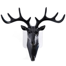 White deer head self-adhesive wall hook attached to a door, ready for use.