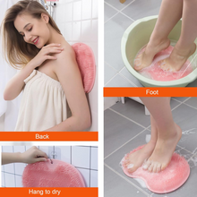 Silicone foot scrubber mat suctioned securely to smooth bathroom surface