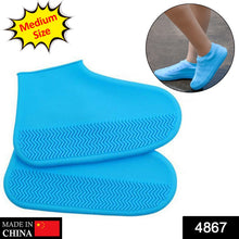 Two blue silicone shoe covers with textured soles, with a 