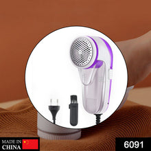 White and purple corded lint remover with a cleaning brush and power plug shown in a circular cutout.