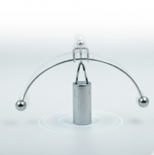 The Newton Cradle's metal balls in mid-swing, illustrating kinetic energy transfer.