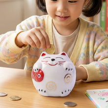 Decorative ceramic piggy bank with cat design, perfect for kids' rooms.