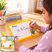 A young girl with dark hair writes “ABC” on a yellow-framed Pexon writing board with a white marker. A small yellow eraser