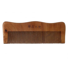 Wooden comb on white background highlighting natural wood finish