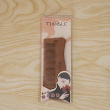 Beautiful wooden comb in packaging, ideal gift for hair care enthusiasts