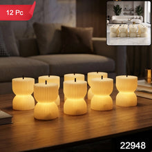 Seven glowing, ribbed, hourglass-shaped LED candles sit on a dark wood coffee table, with a small inset showing more candles.