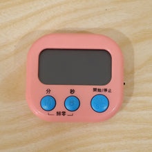 Digital kitchen timer in use during a cooking task with ingredients