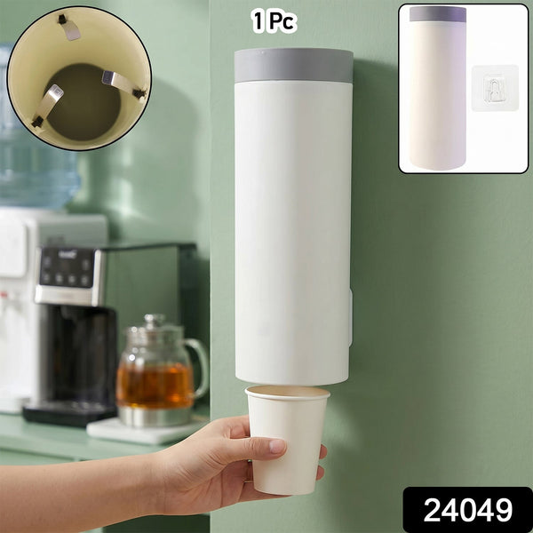 A white wall-mounted cup dispenser with a gray lid, dispensing a white paper cup into a hand, with an inset showing cup