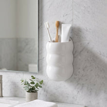 Wall-mounted caterpillar storage holder used for toothbrushes and toothpaste