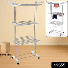 Stainless steel foldable drying rack with clothes drying on its three tiers.