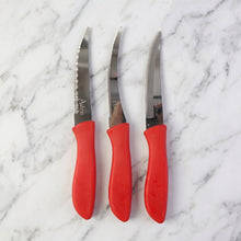 Kitchen knife slicing a tomato